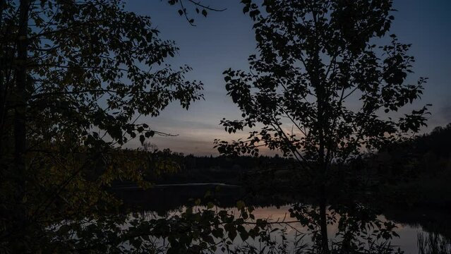 Autumn twilight near a forest lake, beautiful autumn landscape, camera movement, hyperlapse 4k video 4096 2304