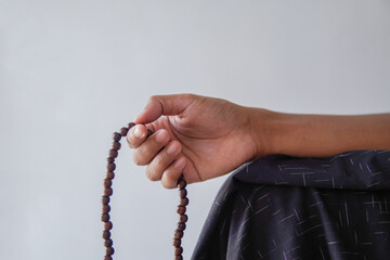 muslim hand holding a prayer beads or tasbih