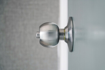 A close up image of an metal door knob