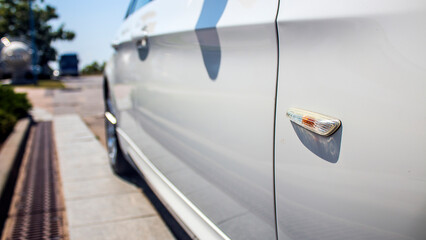 Right side of a white car with marker headlight