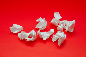 white crumpled paper on red background