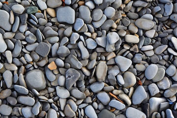 Background of grayish round pebble rocks.