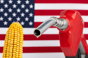 Gas dripping from fuel nozzle with American flag and ear of corn. Gasoline shortage, price and...
