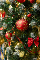 Red baubles and decorations on christmas tree for background. New Year concept.