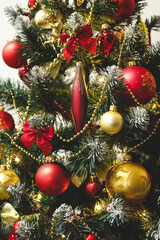Red and golden baubles on christmas tree for background. New Year concept.