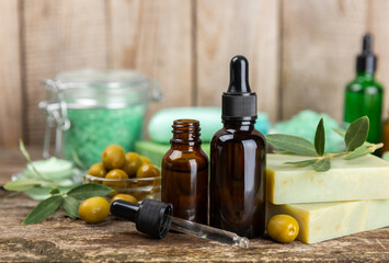 Olive Spa. Essential oils, face and body cream, scrub, sea salt, handmade soap with olive oil extract. Natural cosmetic. Beauty concept. Cosmetic tube. Space for text.Copy space