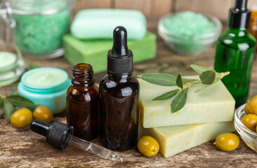Olive Spa. Essential oils, face and body cream, scrub, sea salt, handmade soap with olive oil extract. Natural cosmetic. Beauty concept. Cosmetic tube. Space for text.Copy space