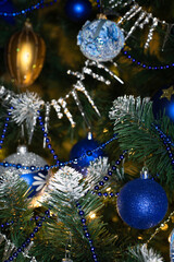 Obraz na płótnie Canvas Blue and silver baubles on christmas tree for background. New Year concept.