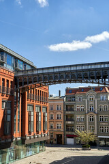 Naklejka premium metal footbridge and Red brick building in an old brewery in Poznan