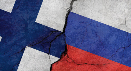 Finland and Russia flags, concrete wall texture with cracks, grunge background, military conflict concept