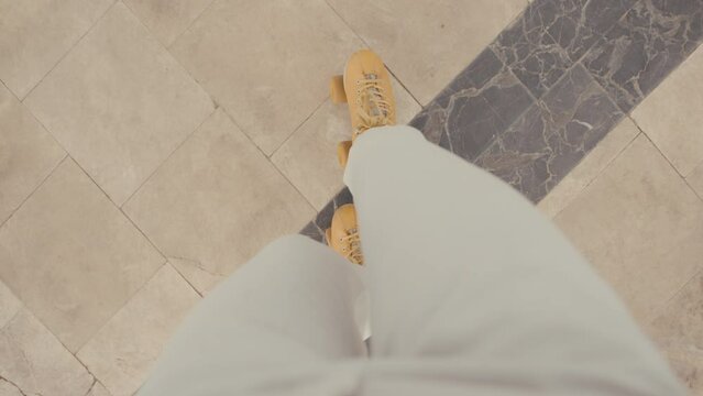 Women's legs in retro roller skates close-up. Woman rides a quad roller