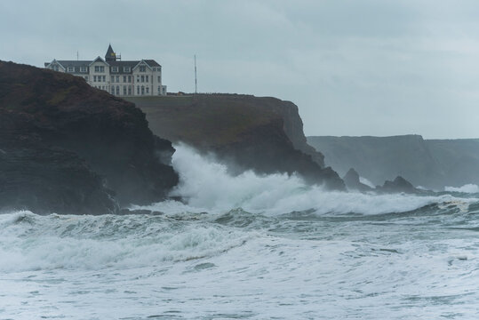 Crashing waves during storm on beach at Church Cove in Cornwall UK landscape image