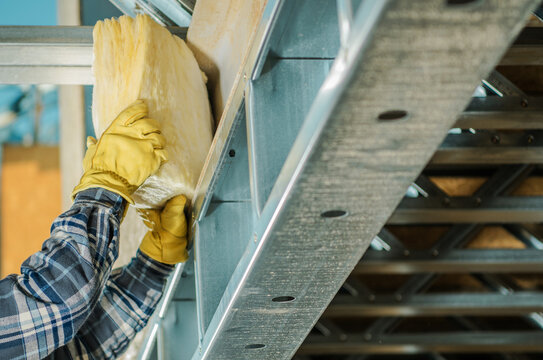 Construction Worker Insulating Frame Elements with a Mineral Wool