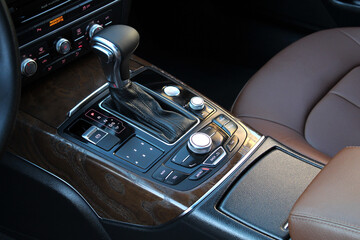 Gear lever. Automatic transmission lever shift. Modern car Center console. Modern luxury car brown leather interior.