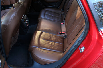 Modern luxury car brown leather interior. Rear brown leather passenger seats. Interior of prestige...