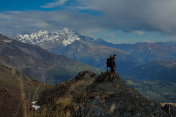 Man in the mountains with a backpack.
