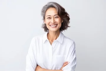 Gordijnen Portrait of Asian senior woman posing on white wall background. © Virtual Art Studio
