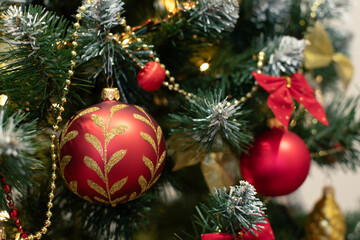 Red baubles and decorations on christmas tree for background. New Year concept.