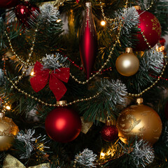 Red and golden baubles on christmas tree for background. New Year concept.