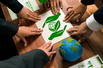 Cohesive group of business people forming jigsaw puzzle pieces in environmental awareness symbol as...