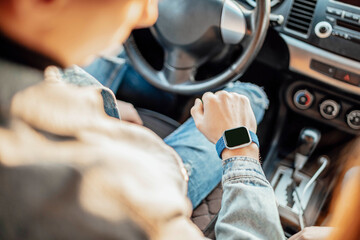 smart watch on the hand of car driver, close up. transport, business trip, technology, time and...