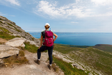 Hiker on path to Goatfell, view over Firth of Clyde, summers day.