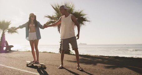 Beach, skateboard and couple with adventure, sunshine and summer break with freedom, love and happiness. Ocean, man and woman skateboarding, journey and relax with seaside holiday, travel and getaway - Powered by Adobe