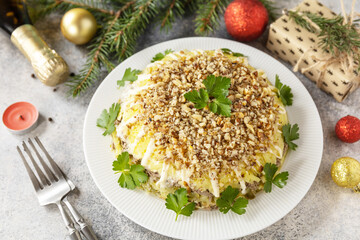 Christmas appetizer. Christmas New Year salad with potatoes, liver and nuts on the festive table.