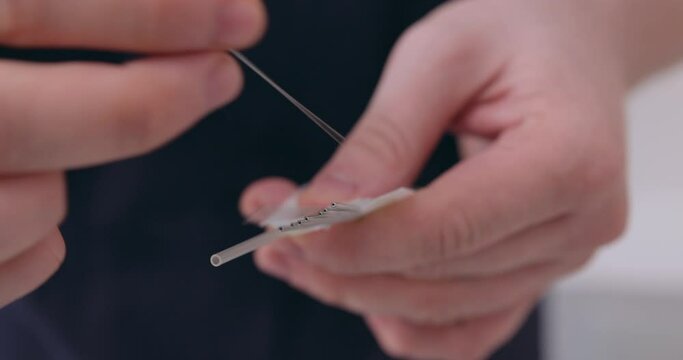 the doctor holding needle in hand, preparing for procedures Chinese medicine Slow motion Worker in physiotherapy clinic holding acupuncture needles health technique, effective treatment from illnesses