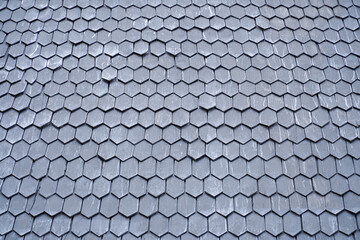 wooden tiles on the roof of a historic building. Wooden shingle roof. Wooden surface texture.