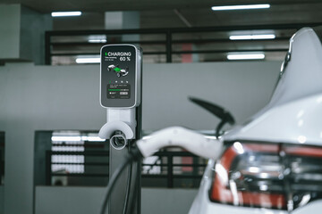 EV electric car recharge at shopping center parking lot charging in downtown city showing urban sustainability lifestyle by green clean rechargeable energy of electric vehicle innards © InfiniteFlow