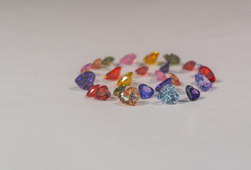 .Heart-shaped gemstones in various colors are set in a circle..Natural stone minerals that are...