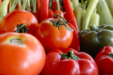 Colorful fresh vegetables and fruits in wooden box, red tomatoes with many vegetables. Organic healthy food for vitamins minerals and nutrients.