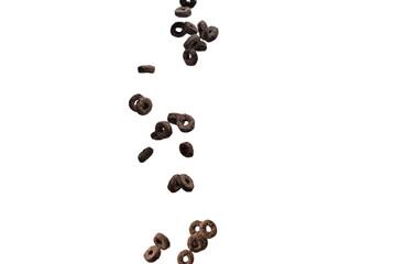 Chocolate rings cereal spill out into a bowl. Breakfast.