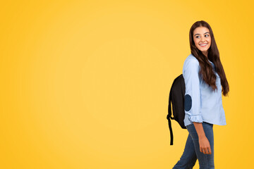 Teen student concentrating on studies, yellow background