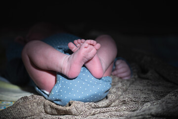 The tiny foot of a newborn baby. Soft feet of a new born. Toes, heels and feet of a newborn. Horizontal image.