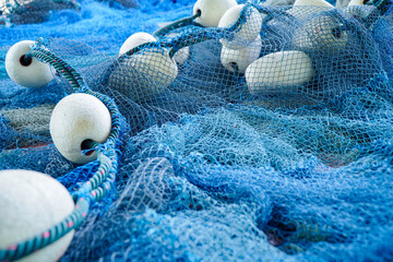 pile of blue fishing net with white floats. Trawler fishing net and floats. Fishing nets and ropes....