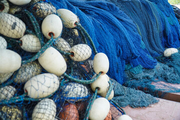 pile of blue fishing net with white floats. Trawler fishing net and floats. Fishing nets and ropes....