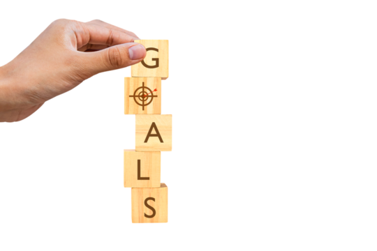 Hand places a wooden cube with the text "Goals" isolated on white background. Business idea towards goal. PNG