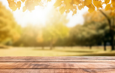 Naklejka na ściany i meble Wooden table in front of blurred autumn park background with copy space. High quality photo