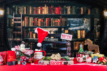 Christmas cookies presents and decorations on red with old library background