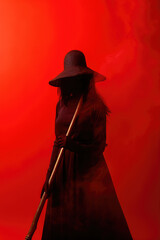 An illustration of a devilish cruel mysterious woman in a Gothic witch dress holding a flying broom isolated by a red background. Generative AI