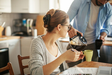 Young couple doing financials in the kitchen