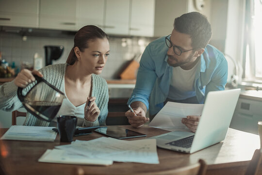 Stressed Young Couple Doing Financials In The Kitchen