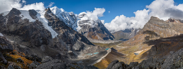 54MP Panoramic photo of Himalaya valley with glacier lakes and snowy summits covered in white clouds. Mera peak climbing route near the Khare settlement, Makalu Barun National Park trek in Nepal.