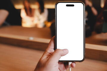 A man is sitting in a cafe, holding a blank screen mock-up mobile phone in cafe.
