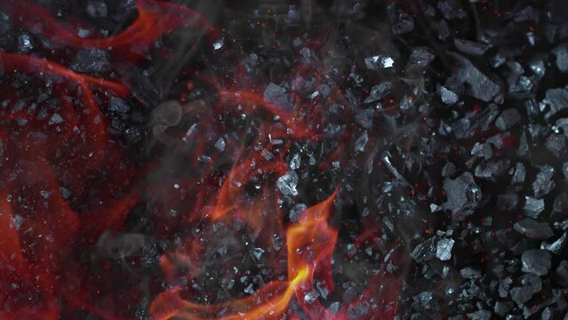 Super Slow Motion Shot of Coal, Flames and Sparks Explosion Towards Camera at 1000 fps.