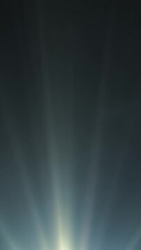 Looped animated blue light rays on dark background in vertical composition format at 60 fps