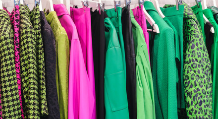 Fashion clothes on clothing rack  Closeup of rainbow color choice female wear on hangers in store closet  Summer home wardrobe.