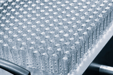 Glass ampoule in production in the tray of an automatic liquid dispenser, a line for filling medicines against bacteria and viruses, antibiotics and vaccines.